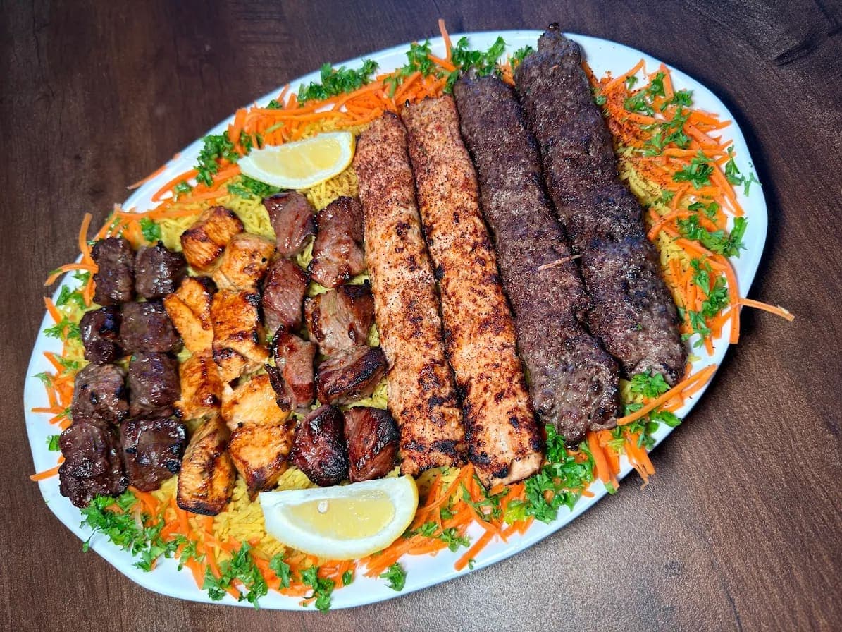 Family Meal mixed grill platter — chicken tikka, lamb tikka, shish and kofta kebabs over rice, Maza Mediterranean Cuisine Chandler AZ